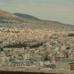 a view of a city with mountains in the background